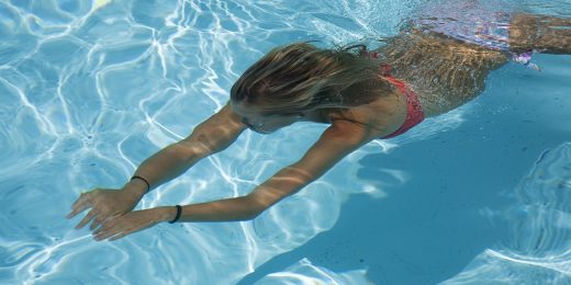 Young girl swimming under water