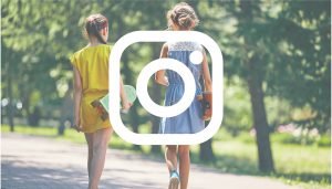 Bild med två tjejer med skateboards i grönska med instagram logotypen ovanpå